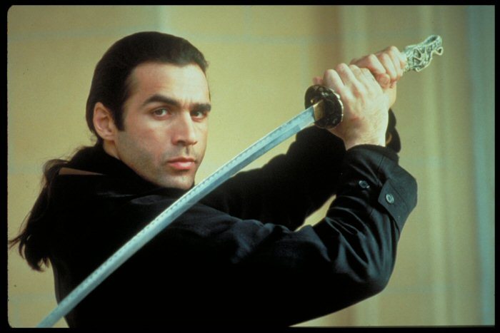 Dude from Highlander with a long ponytail, a sword over his shoulder, and some seriously evocative eyebrows