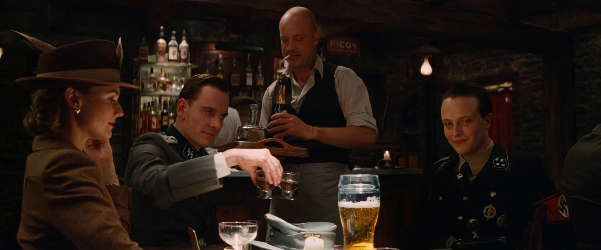 Image Archie Hicox shares the whiskey glasses as Bridget and Hellstrom look down.jpg