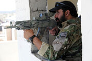 Afghan border police aiming a weapon
