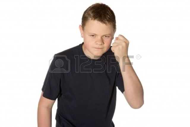 File:14129266-angry-casual-young-man-in-a-black-t-shirt-with-glaring-eyes-shaking-his-fist-at-the-camera-isolated-.jpg