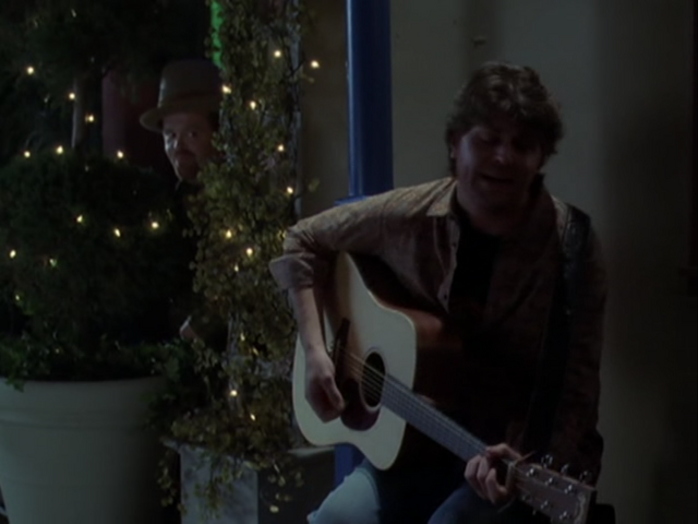 File:5x17StreetPerformerPlaying.png