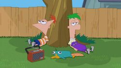 Boys relaxing under tree