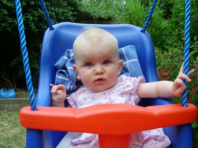 File:Swinging-in-the-garden-7-seven-month-old-baby-girl.jpg
