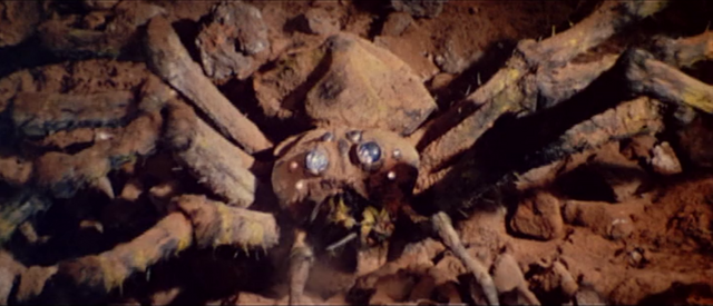File:All Monsters Attack - Kumonga appears via stock footage.png
