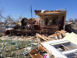 An image depicting the remains of a destroyed double-wide mobile home in Sand Springs, Oklhoma.