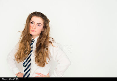 A-bored-fed-up-moody-13-14-15-year-old-teenage-schoolgirl-with-long-EHAC23