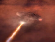 USS Defiant feuert Phaser durch die Deflektor-Phalanx in Atmosphäre von Gaßriesen.jpg