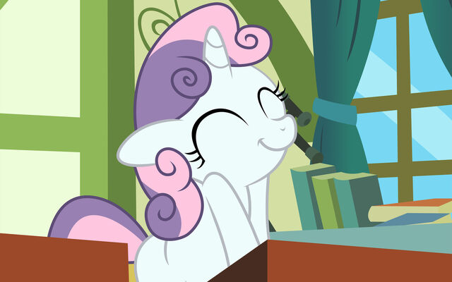 File:Sweetie smiling at desk.jpg