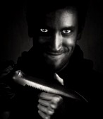 2307804-black-and-white-shot-of-man-with-a-knife-smiling-hysterically