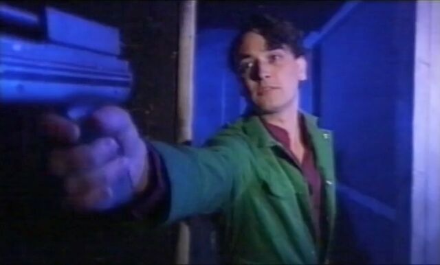 File:Nikos holding gun.jpg