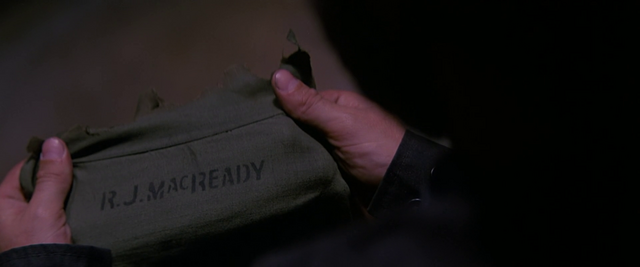 File:Torn clothing with MacReady name-tag - The Thing (1982).png