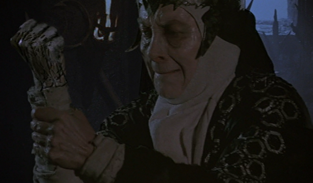 File:Bavmorda's arm turning to stone.png