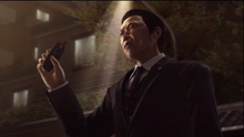 Aoyama holds the rig remote front of Kiryu